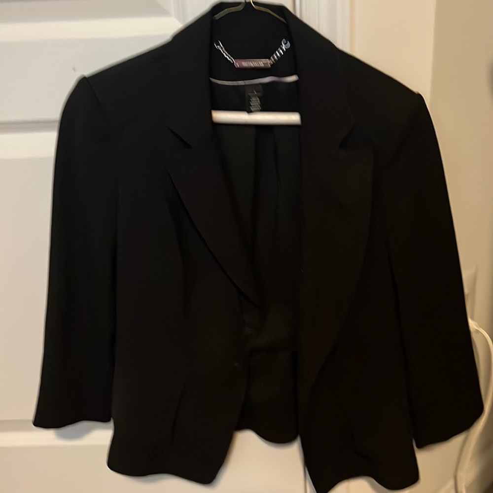 suit jacket flared in black with buckle.  button down in front